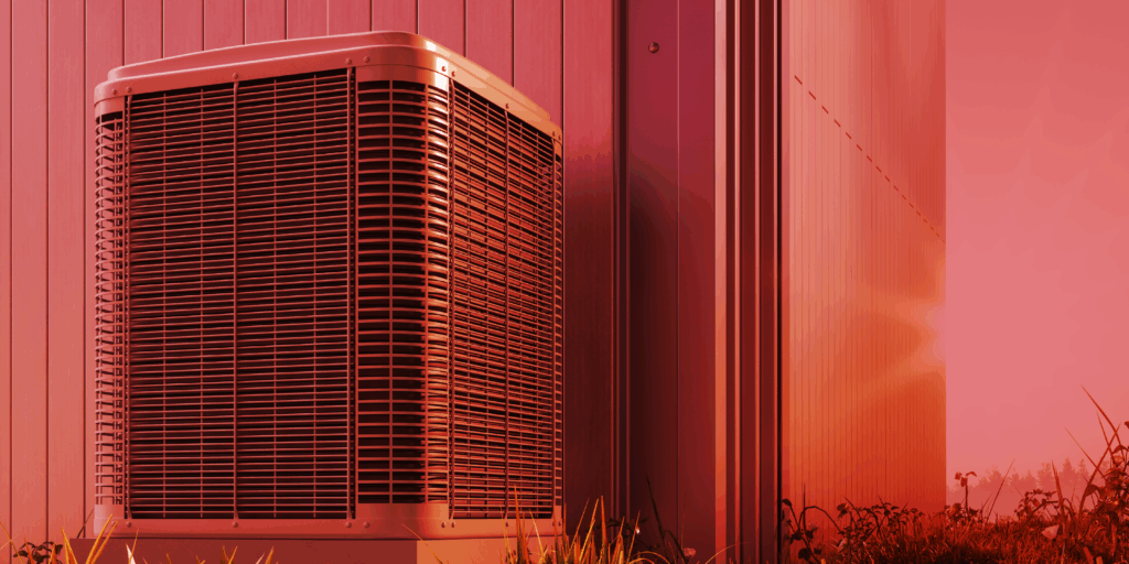 Red Air conditioner on the side of a house in a heat wave